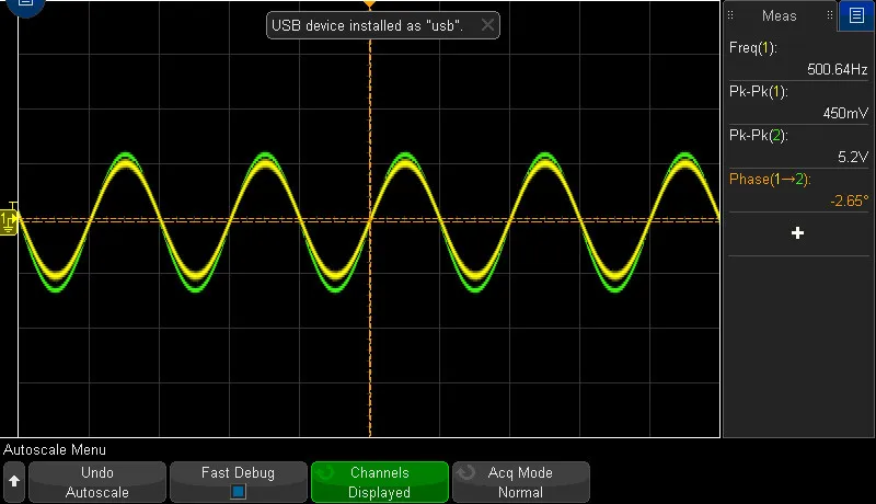 Oscilloscope trace showing a small output sine against a much larger input sine at 500 hertz