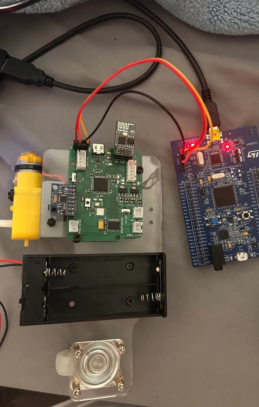 The robot board wired with four jumpers to an STM32F4 Discovery board used as a programmer